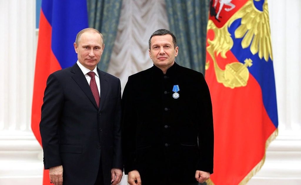 Vladimir Putin with Vladimir Solovyev wearing one of his main state awards, the Order of Honor, which he received for his “large contribution to the development of Russia’s culture and art.” Kremlin, December 25, 2013