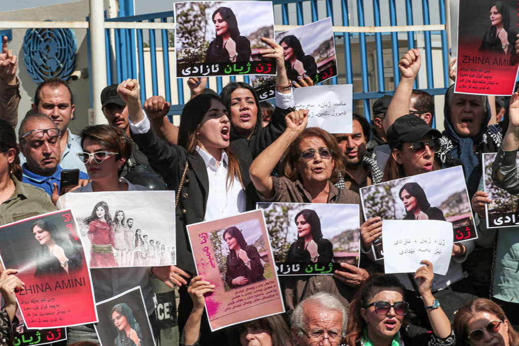 Женщины скандируют лозунги и держат плакаты с изображением 22-летней Махсы Амини, погибшей во время задержания иранскими властями, Арбила, Курдистан, 24 сентября 2022 года. Все диктаторы — феминисты 