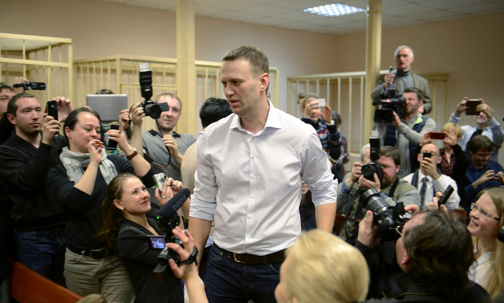 В 2013 году началось дело «Кировлеса». По версии следствия, в 2009 году Алексей Навальный, работая советником губернатора Кировской области Никиты Белых, участвовал в «хищении», организовав сделку по продаже древесины по заниженным ценам. СМИ и независимые эксперты считают дело политически мотивированным. Навального признали виновным и приговорили к пяти годам лишения свободы, позднее изменив наказание на условный срок. На фото Навальный на заседании суда и в перерывах. 